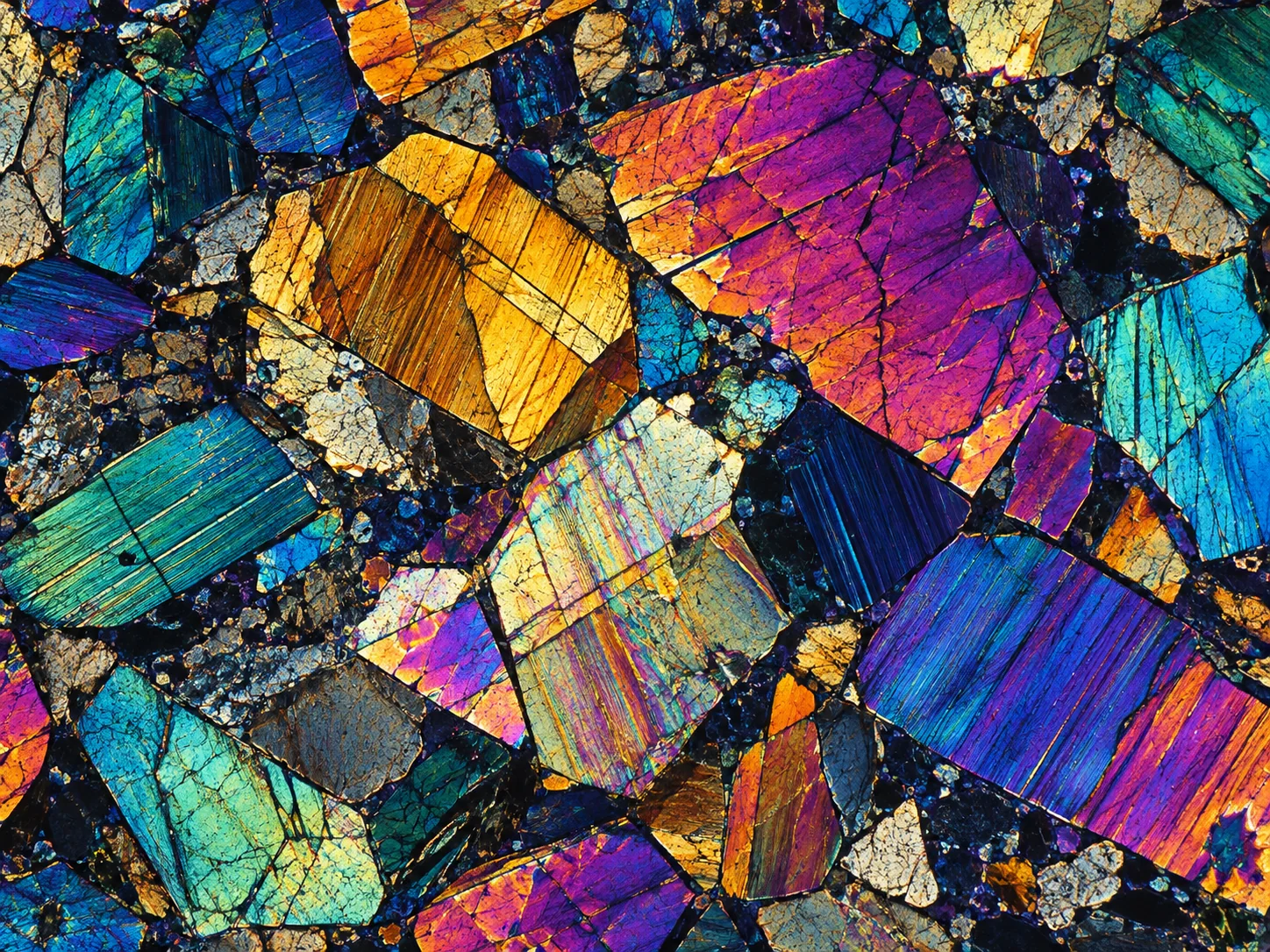 Polarized-light-inspired illustration of colorful interlocking mineral-like grains